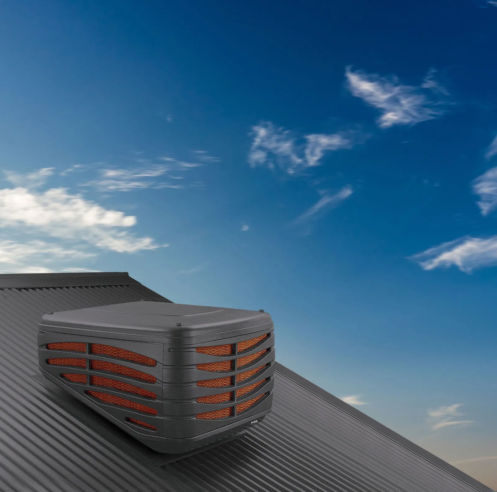 Brivis Contour evaporative cooler on a metal roof at sunset