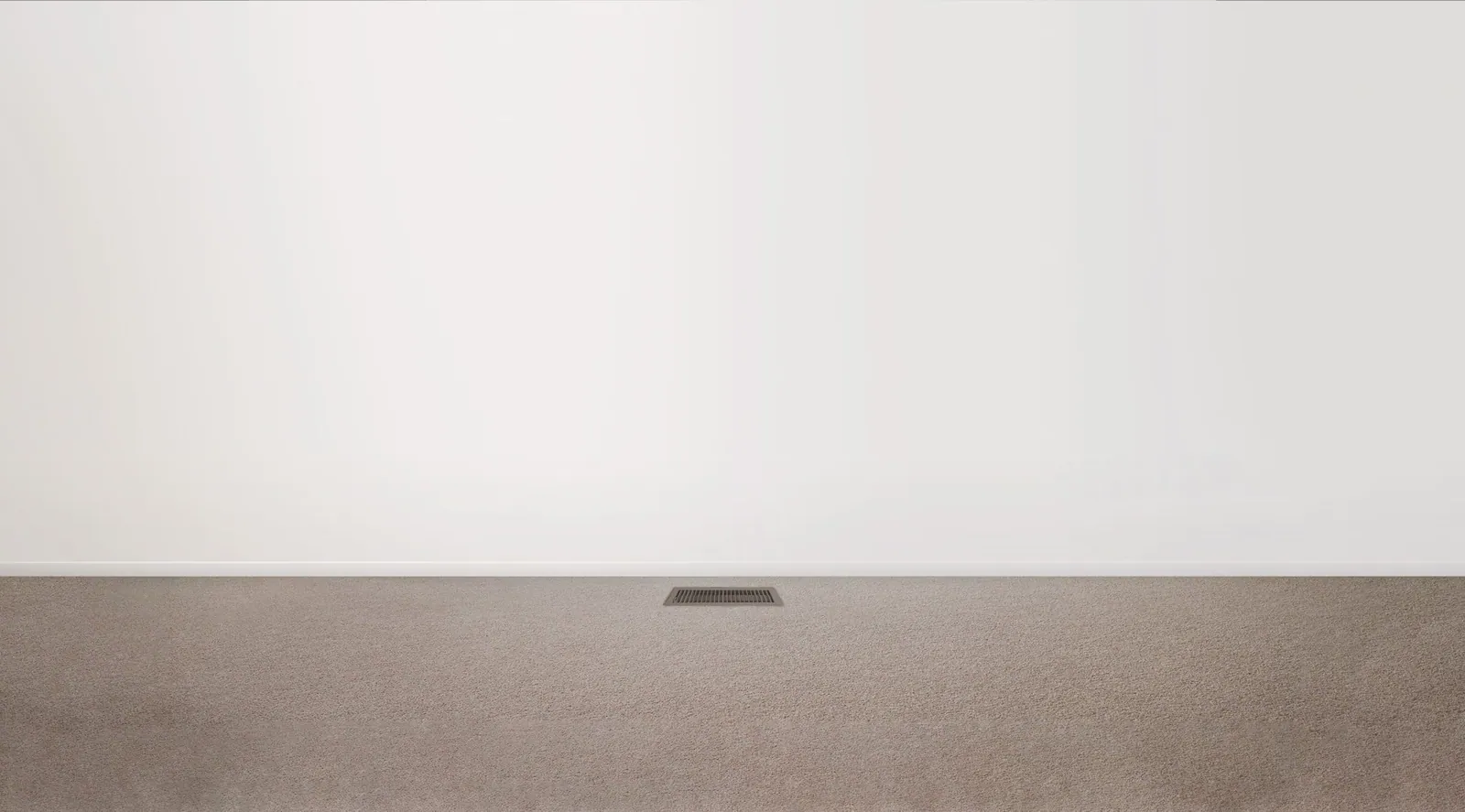 Floor vent of a gas ducted heating system set into carpet in a warm, light-filled room