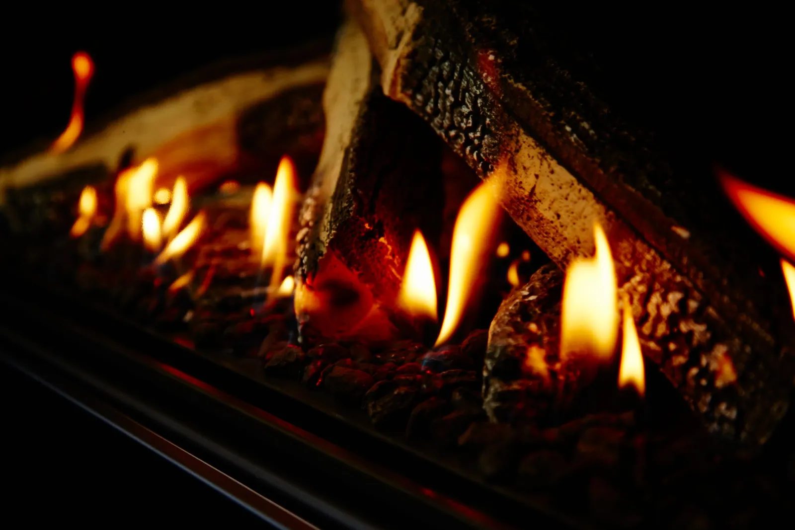 Close-up of the flames and ceramic log set inside a Rinnai 1250 gas log fire