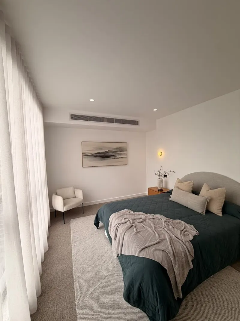 Main bedroom with a ceiling outlet from a ducted reverse cycle system
